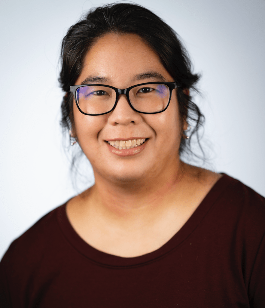 Headshot photo of Kara Hisatake, who is wearing glasses and a maroon top. 